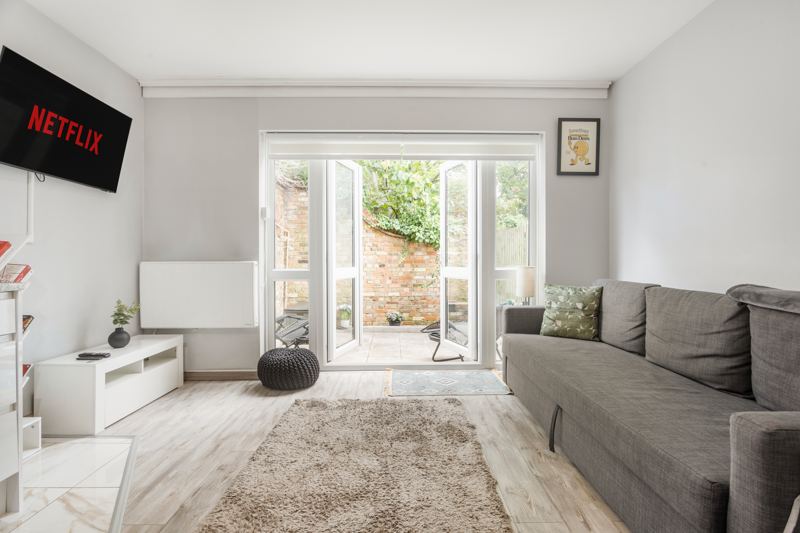 Living room with French doors open to the garden