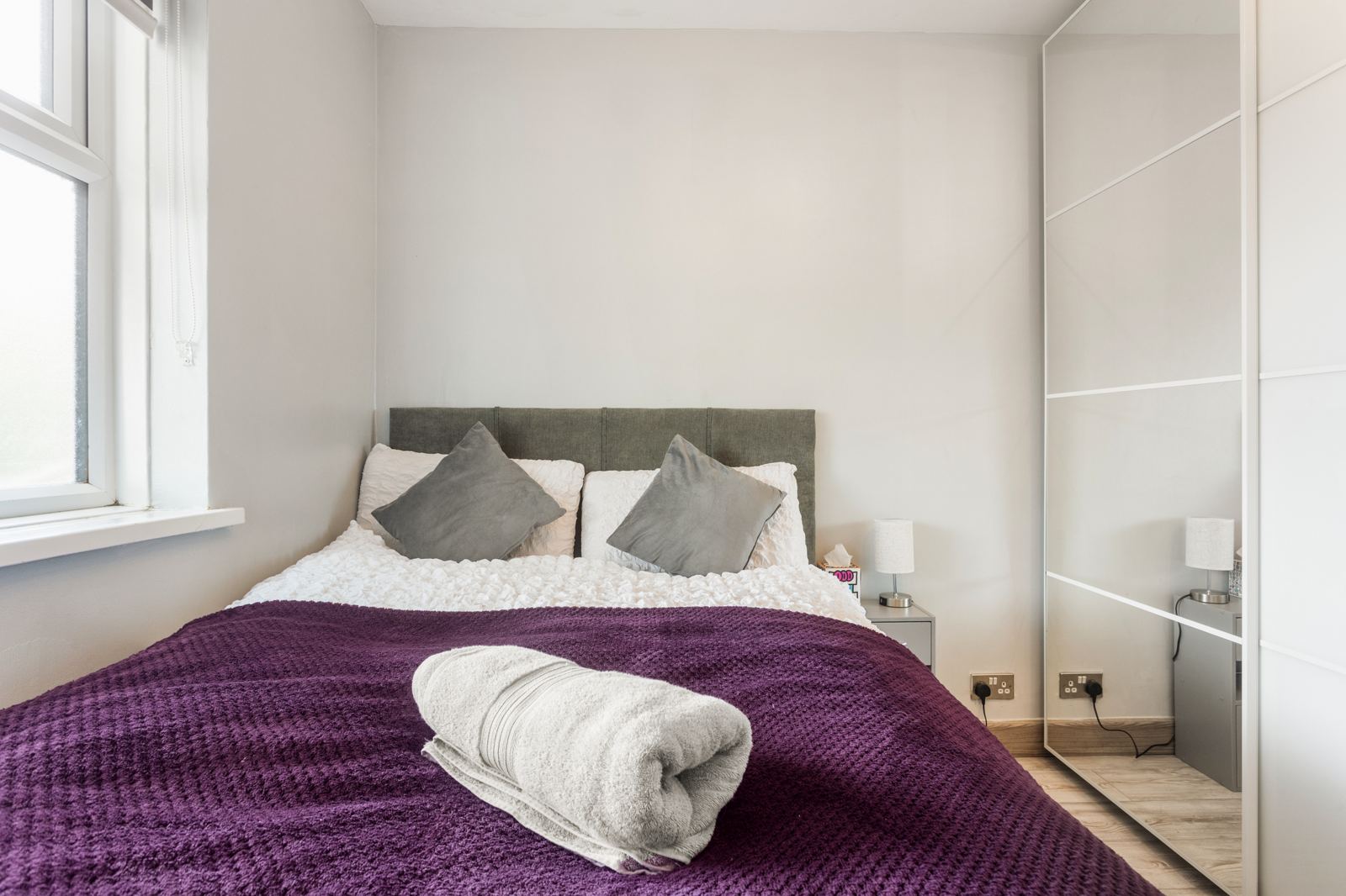 Bedroom with mirrored wardrobe