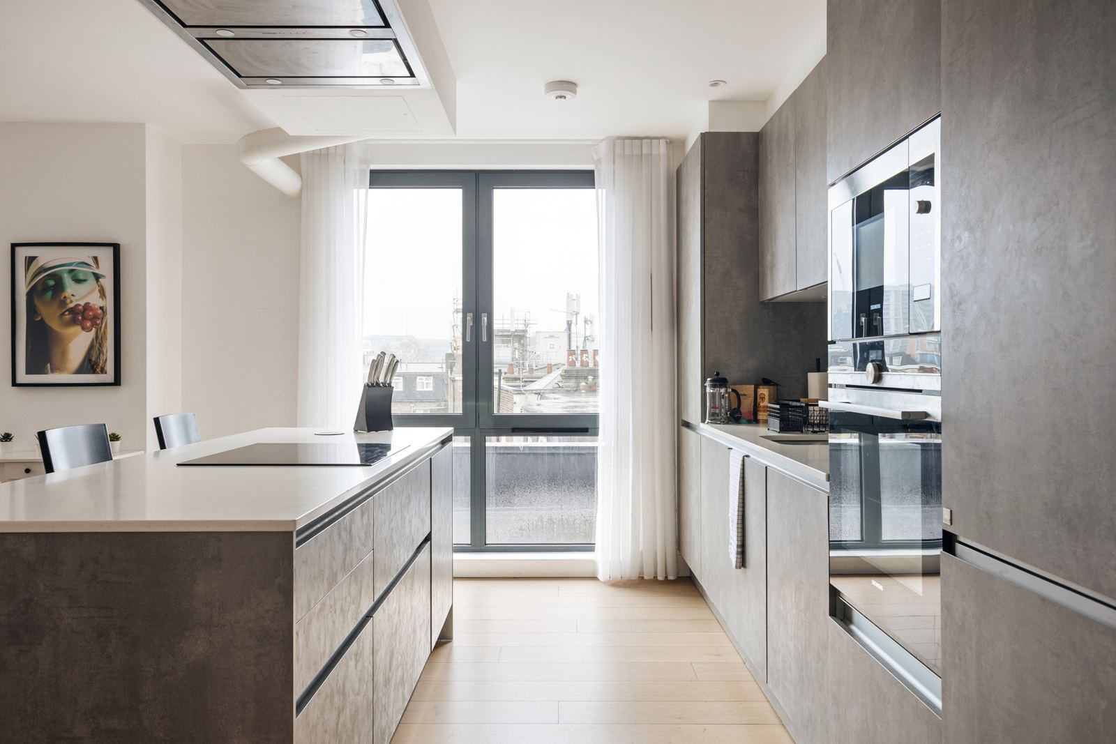 Kitchen with a window over the rooftops