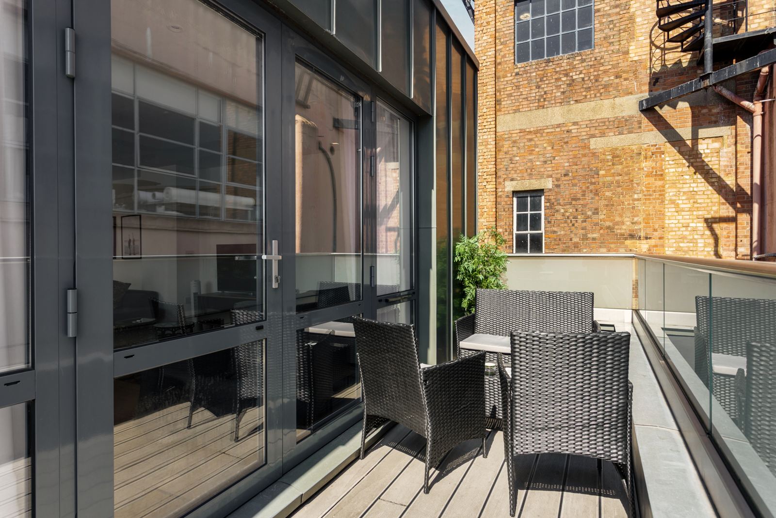 Balcony with rattan chairs and a small table