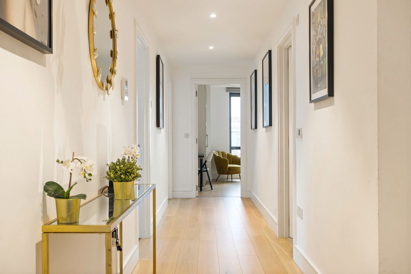Hallway with gold mirror and console table