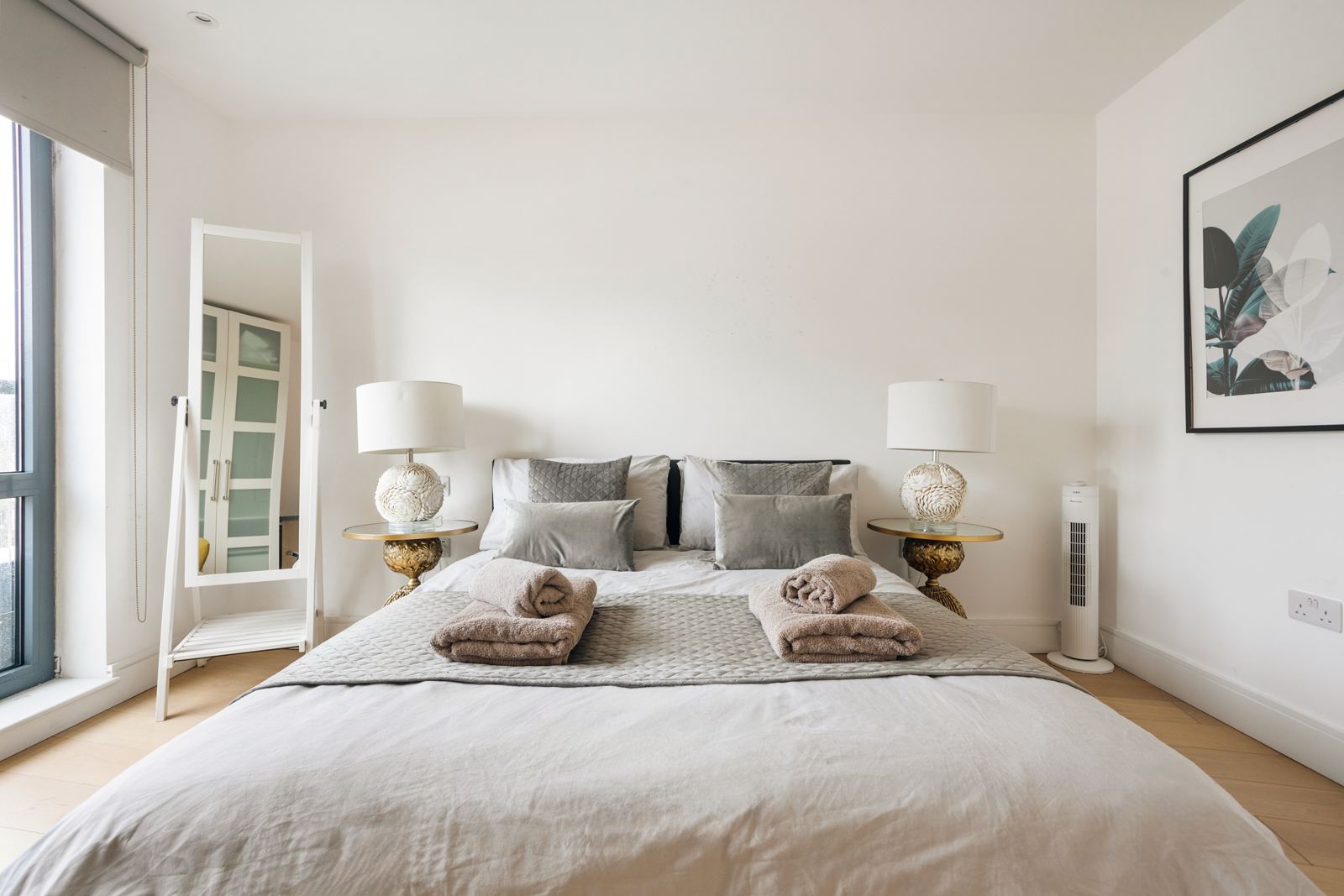 Bedroom with shell lamps and gold side tables