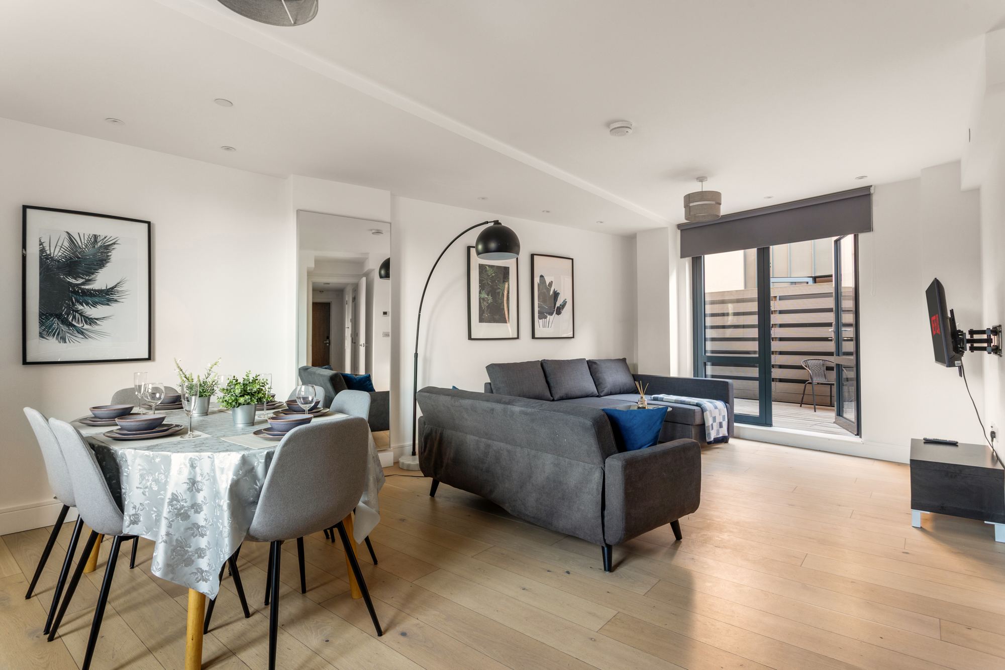 Open-plan living and dining room with doors open to the terrace